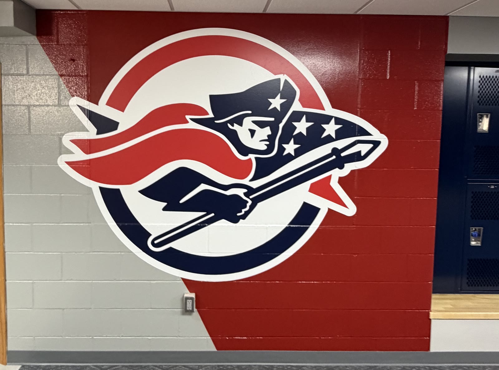 Red, white and navy Patriots graphic installed on an interior block wall