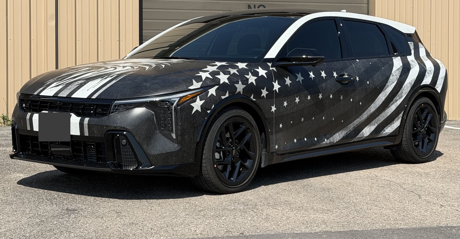 SUV with black and white stars-and-stripes custom graphics across the hood and sides